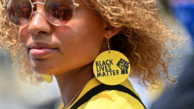 A woman wears "Black Lives Matter" jewelry to a Juneteenth party in Scranton, Pennsylvania, in 2021.