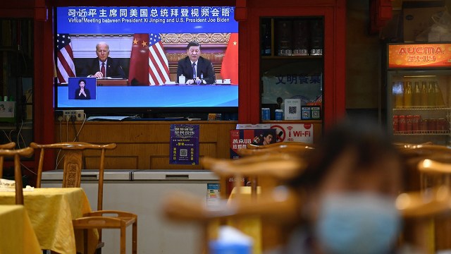 A televised news program in Beijing shows a virtual meeting between Chinese President Xi Jinping and U.S. President Joe Biden in November 2021.
