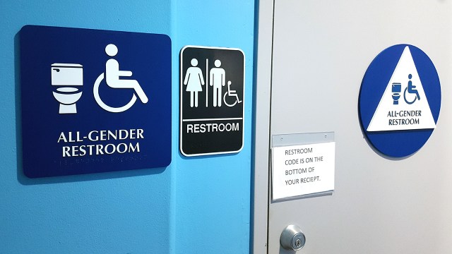Signs mark an all-gender restroom in San Ramon, California, in 2017.