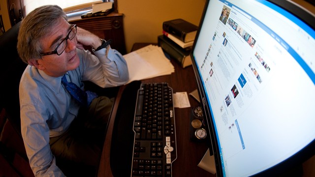 Former Rep. Brad Miller, D-N.C., checks his Facebook page in his office in July 2011.