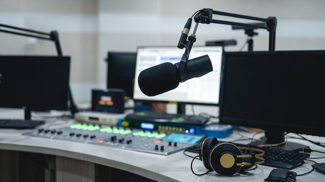Photo showing a studio microphone and mixing board (Wang Yukun via Getty Images)