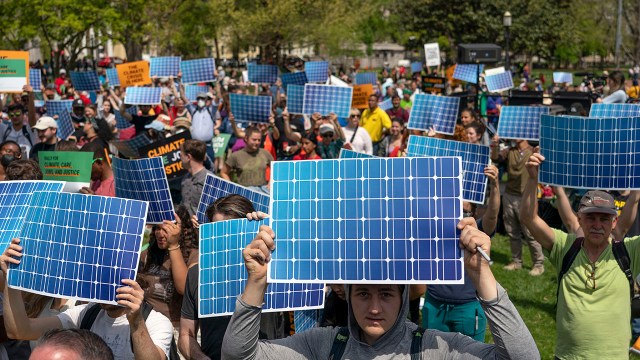 Activists display prints replicating solar panels during a rally to mark Earth Day at Lafayette Square in Washington, D.C., on April 23, 2022. (Gemunu Amarasinghe/AP File)
