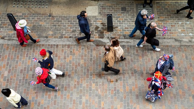 Monarchists and supporters of the British royal family walk through the streets of London ahead of the coronation of King Charles III on May 6, 2023. (Andy Soloman/UCG/Universal Images Group via Getty Images)