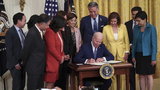 President Joe Biden signs a bill at the White House on June 13, 2022, establishing a commission to study the potential creation of a National Museum of Asian Pacific American History and Culture. (Win McNamee/Getty Images)