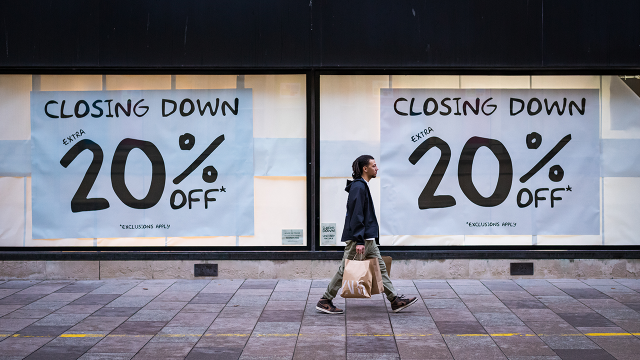 A pedestrian passes a "closing down" store sign in Cardiff, Wales, in 2023. (Matthew Horwood/Getty Images)