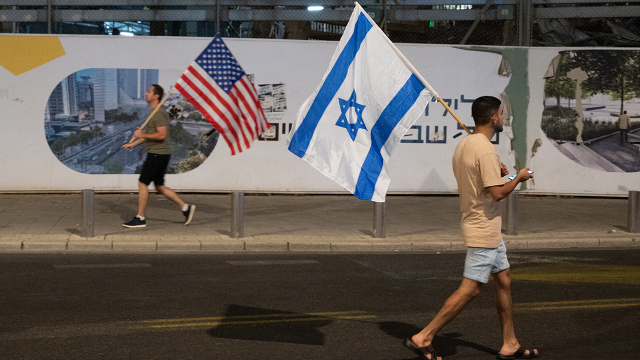 Protesters hold Israeli and U.S. flags during a demonstration against the Israeli government’s judicial reform bill on July 18, 2023, in Tel Aviv, Israel. (Noam Galai/Getty Images)