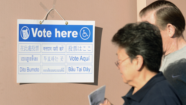 A sign directing voters to polling stations at a fire station in Alhambra, Los Angeles County, on Nov. 6, 2012. (Frederic J. Brown/AFP via Getty Images)