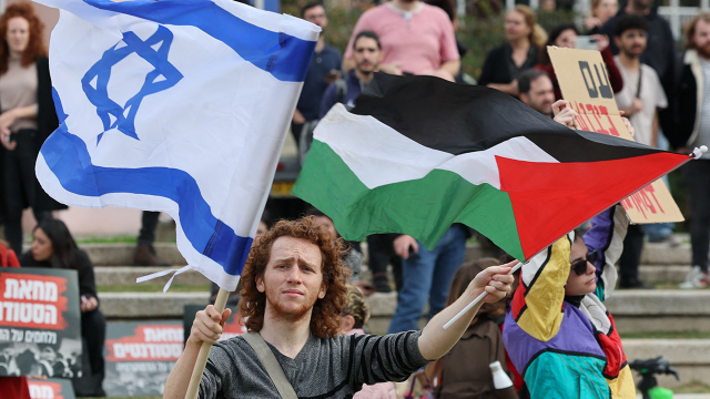 Israeli students at Tel Aviv University hold Palestinian and Israeli flags while protesting Prime Minister Benjamin Netanyahu's new government on Jan. 16, 2023. (Jack Guez/AFP via Getty Images)