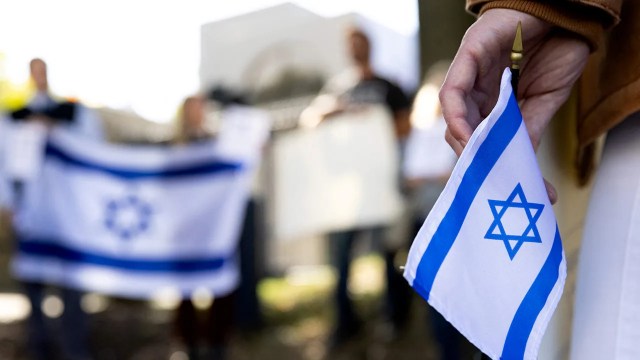 Supporters hold Israeli flags in front of the Israeli Embassy in Washington, D.C., on Oct. 8, 2023, after Hamas launched a surprise attack on Israel. (Julia Nikhinson/AFP via Getty Images)