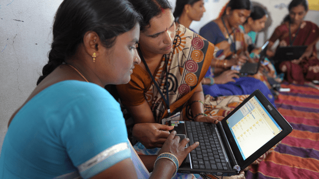 Women work on laptops in the Bibinagar village outskirts of Hyderabad, India, in 2013. (Noah Seelam/AFP via Getty Images)