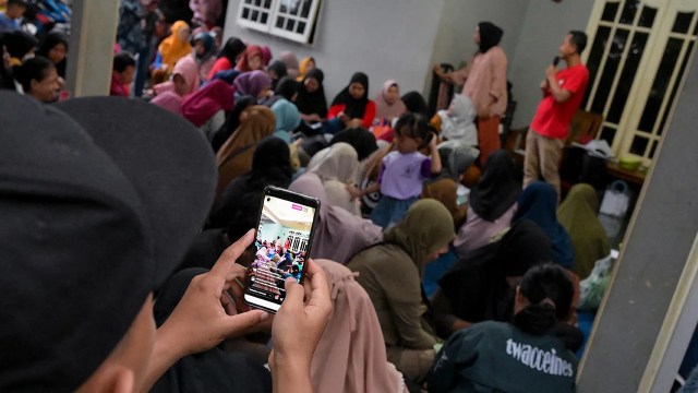 A man records a video for a legislative candidate's social media account on Jan. 10, 2024, in Tangerang, Banten province, Indonesia. (Bay Ismoyo/AFP via Getty Images)