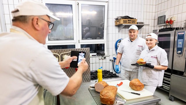 Members of the Richter family shoot a video for social media featuring their butcher shop in Wolsdorf, Germany, in November 2023. (Michael Matthey/picture alliance via Getty Images)