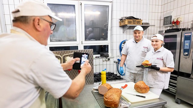 Members of the Richter family shoot a video for social media featuring their butcher shop in Wolsdorf, Germany, in November 2023. (Michael Matthey/picture alliance via Getty Images)