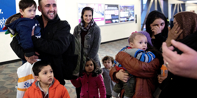 Mohammad Mobin smiles on Feb. 1 after greeting his sister's family, who had arrived as refugees from Afghanistan at an air base near Omaha, Nebraska. (Megan Farmer/Omaha World-Herald via AP)