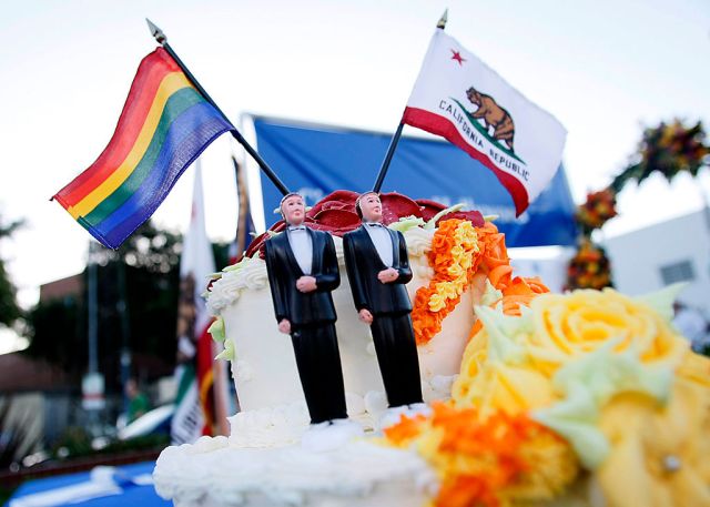 A samesex wedding cake adorns the stage where thousands of people gather to celebrate the Californ