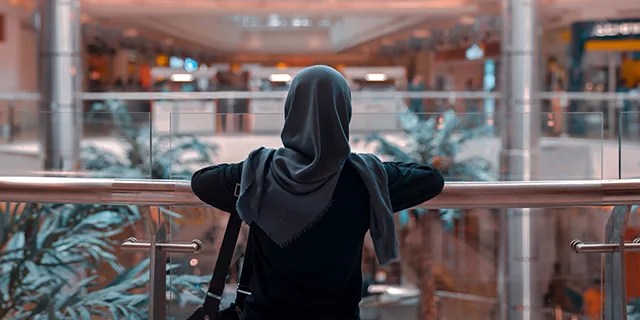 Rear View Of Woman In Hijab Standing At Shopping Mall