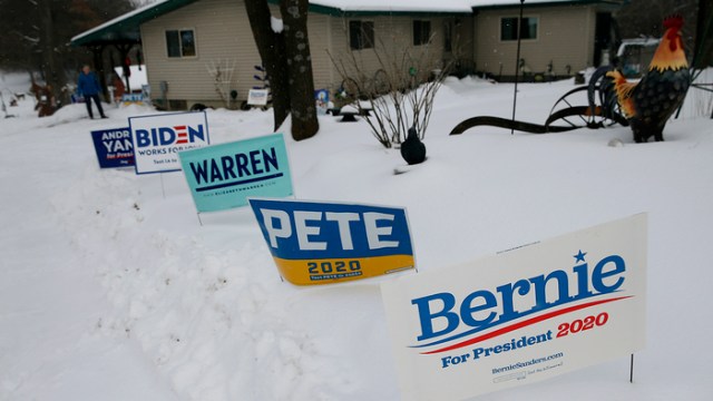 Campaign signs are visible in a front yard in Waverly, Iowa, on Jan. 25, 2020. (Boston Globe via Getty Images)