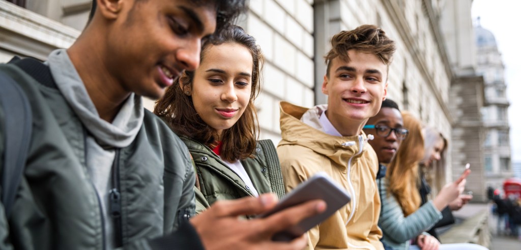 Teenagers students using smartphone on a school break