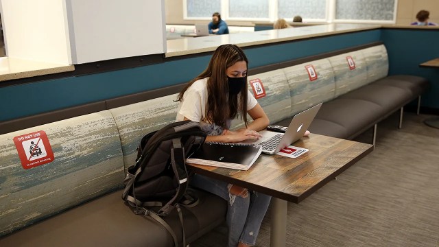 Sophomore Katherine Pacheco sits alone to do remote schoolwork at Boston University in Boston on Sept. 23, 2020. (Jessica Rinaldi/The Boston Globe via Getty Images)