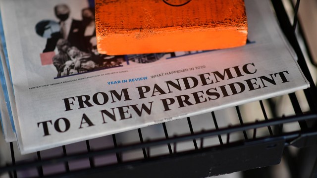The front page headline of a newspaper states “FROM PANDEMIC TO A NEW PRESIDENT” on December 31, 2020 in Rehoboth Beach, Delaware. (Mark Makela/Getty Images)