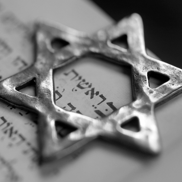 A six pointed metal star symbol on top of paper