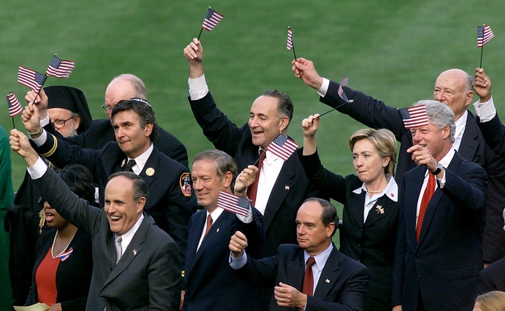 New York City Mayor Rudolph Giuliani (L) leads a g
