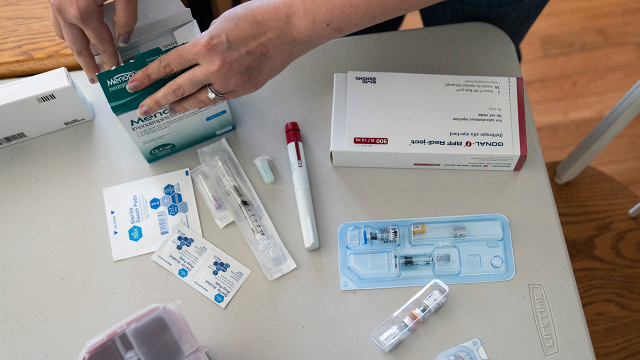 An IVF patient goes through her medications and treatment supplies at her home. (Carolyn Van Houten/The Washington Post via Getty Images)