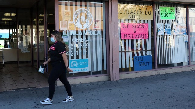 A medical clinic displays signs in Spanish and English in Huntington Park, California, in December 2020. (Dania Maxwell/Los Angeles Times via Getty Images)