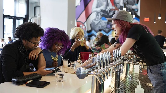 A bartender serves customers at a brewery in Washington, D.C. (Deb Lindsey/The Washington Post via Getty Images)