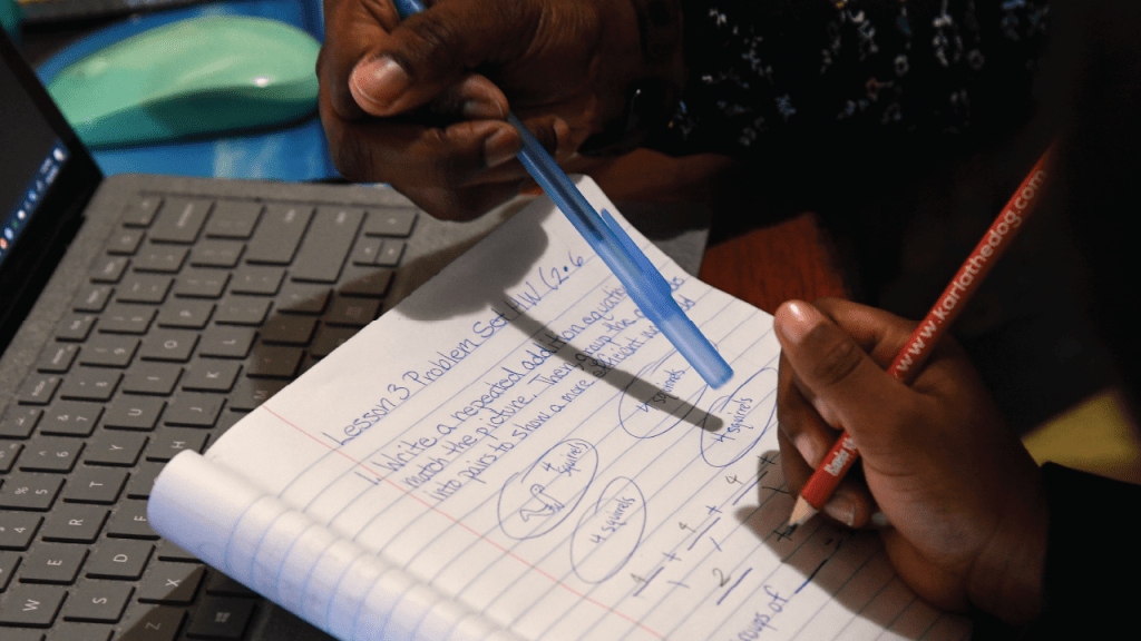 Eagle Academy Public Charter School Congress Heights second grader Kenard Brisbon, 7, gets some help from his mom Janille Thompson with a math lesson on Friday, April 3, 2020. Brisbon first watched a lesson online and then had too follow it with a worksheet that was also posted online. (Photo by Toni L. Sandys/The Washington Post via Getty Images)