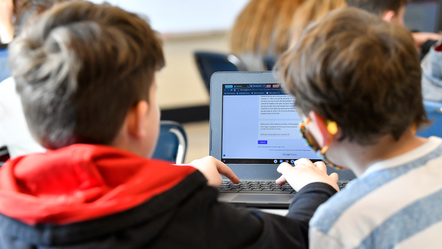 Students at Stonewall Elementary in Lexington, Kentucky, try to figure out whether text was written by fellow students or generated by the artificial intelligence tool ChatGPT in a class exercise on Feb. 6, 2023. (Timothy D. Easley/AP)