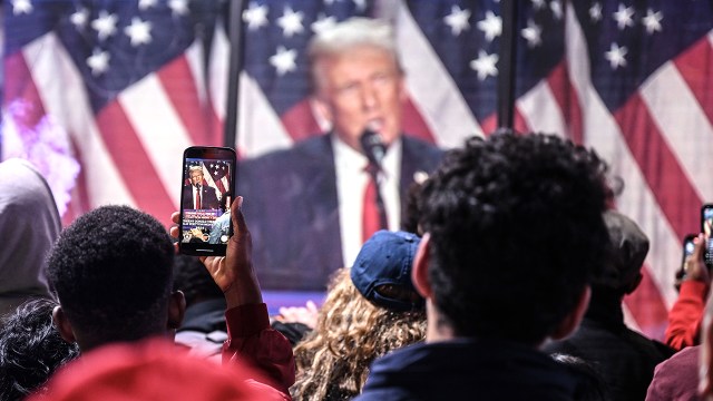 People in New York City watch on a screen as Donald Trump addresses his supporters while votes are counted on Nov. 6, 2024. (Fatih Aktas/Anadolu via Getty Images)
