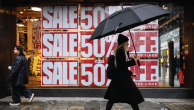 A woman walks past a window display promoting a sale in London on Dec. 13, 2024. (Leon Neal/Getty Images)