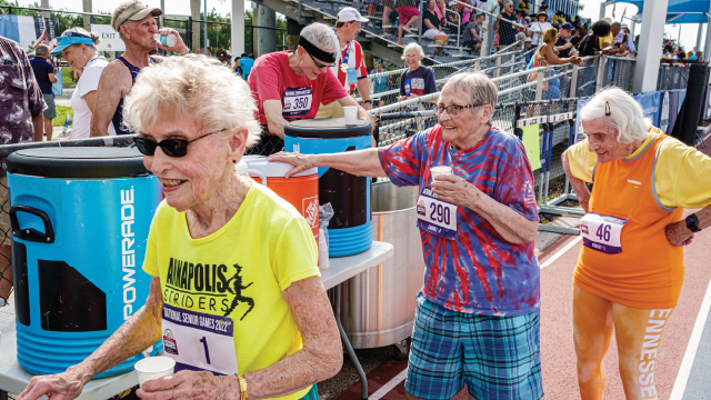Photo showing women runners ages 90 and older grab water after the National Senior Games track and field race in Fort Lauderdale, Florida. (Jeffrey Greenberg/Universal Images Group via Getty Images)