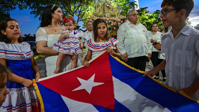 Photo of Children hold a Cuban flag during a feast day celebration honoring the country's patron saint in Hialeah, Florida, on Sept. 7, 2024. (Giorgio Viera/AFP via Getty Images)