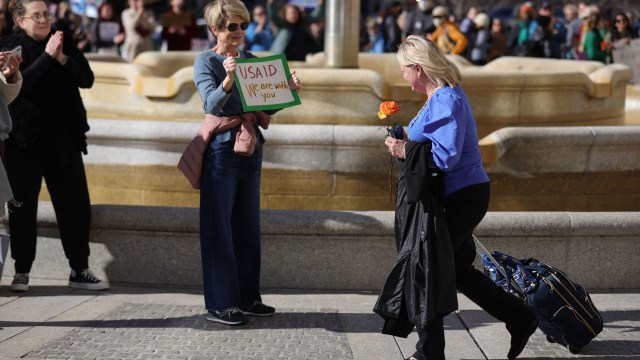 A laid-off federal worker leaves the offices of the U.S. Agency for International Development in Washington, D.C., on Feb. 28, 2025. (Bryan Dozier/Middle East Images/AFP via Getty Images)