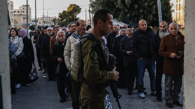 Palestinian Muslims gather at a checkpoint in the West Bank city of Bethlehem on February 20, 2026. (Hazem Bader/AFP via Getty Images)