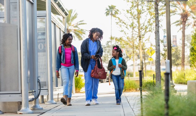 African-American working mother takes daughters to school