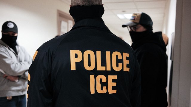 Masked federal agents wearing a Police ICE jacket, stand in a hallway at the New York Federal Plaza Immigration Court inside the Jacob K. Javitz Federal Building in New York on March 17, 2026. US President Donald Trump has made deporting undocumented immigrants a key priority for his second term, after successfully campaigning against an alleged "invasion" by criminals. (Photo by CHARLY TRIBALLEAU / AFP via Getty Images)