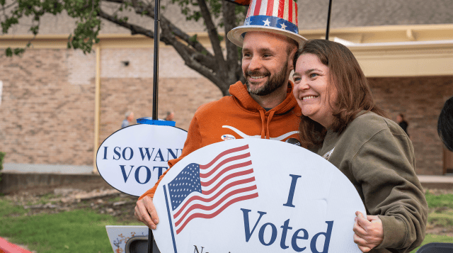 Voters pose with props outside a polling location in Austin, Texas in 2026. (Mikala Compton/The Austin American-Statesman via Getty Images)